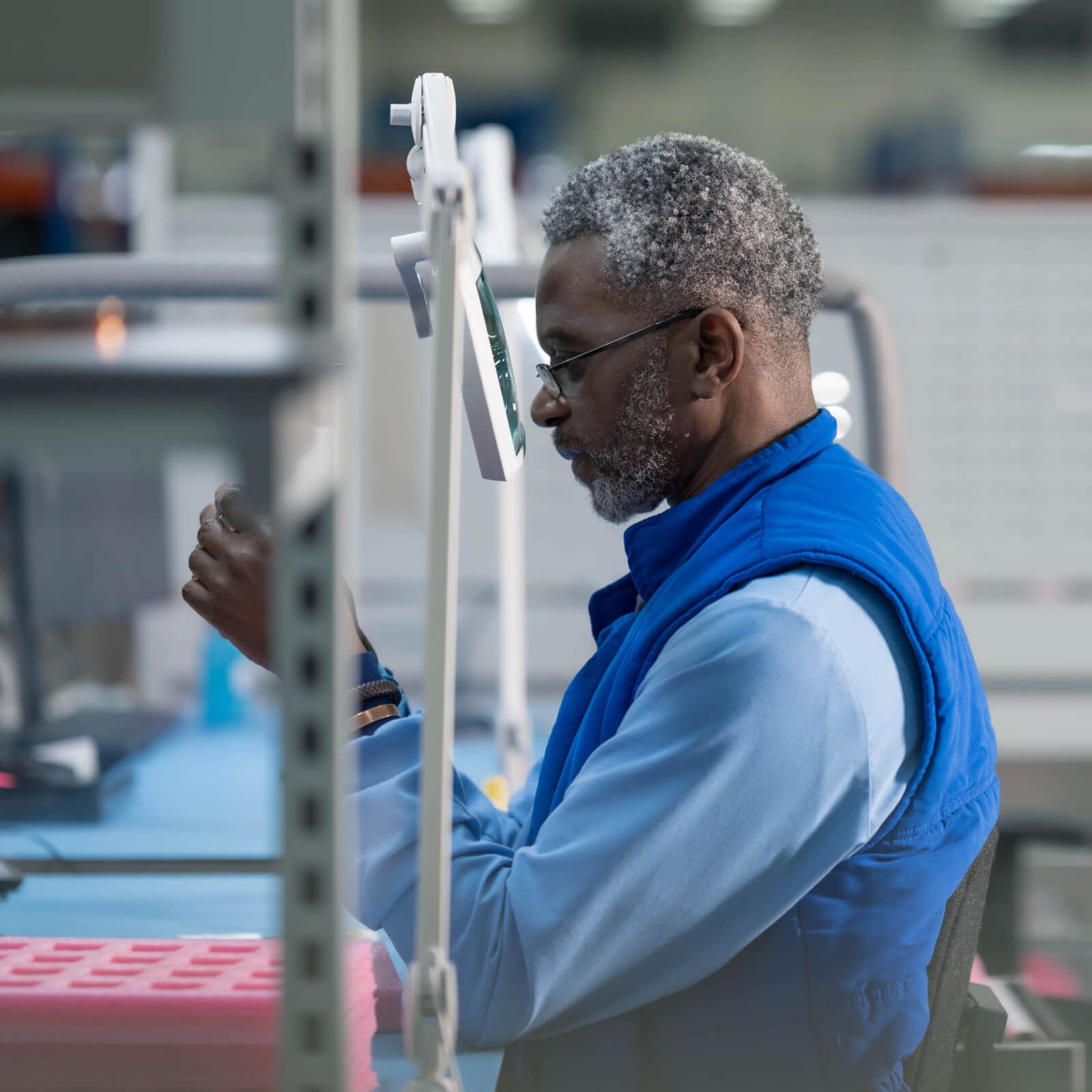 man-inspecting-circuit-board